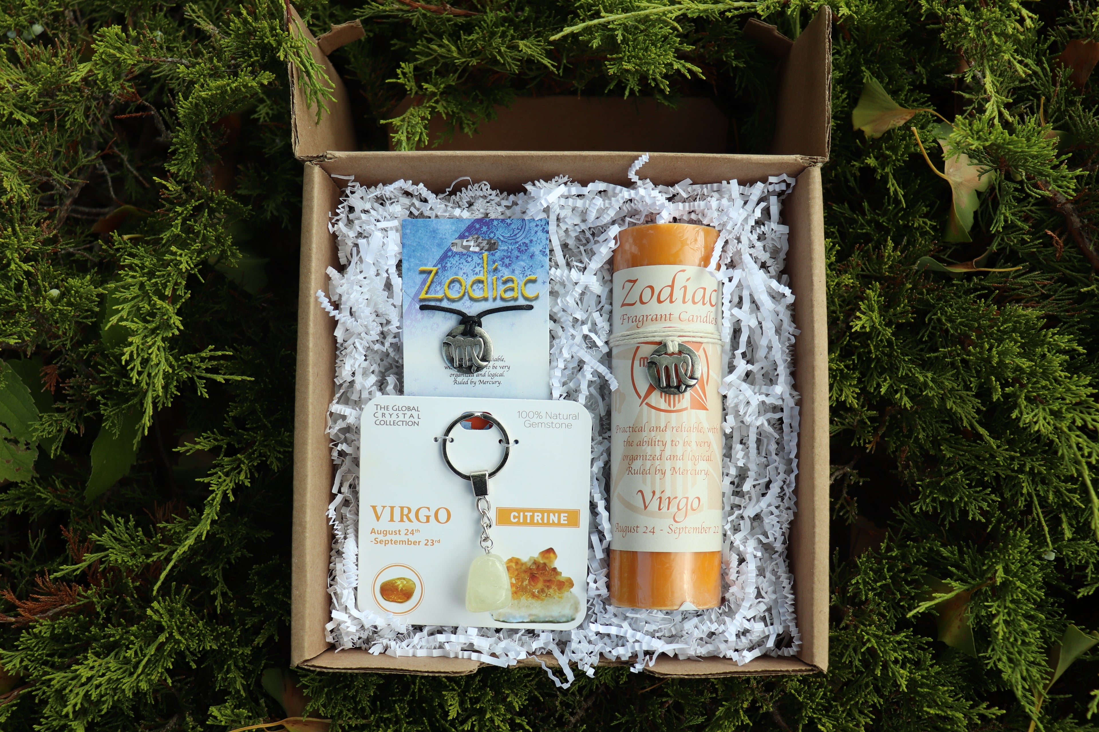 Gift box with Zodiac products on a green leafy background