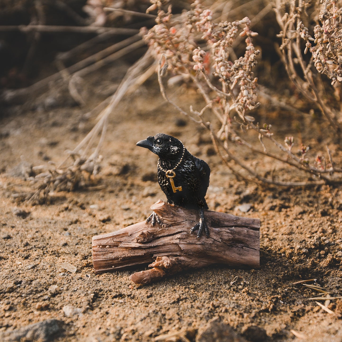 Miniature Raven with Key on Log