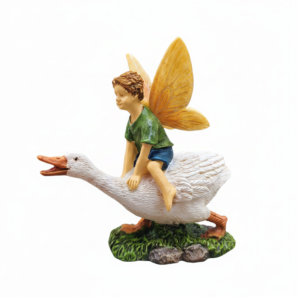 Fairy riding a goose figurine on a concrete surface with greenery in the background