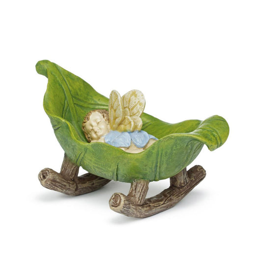 A sweet baby fairy is fast a sleep for an afternoon nap in a cradle made from branches and leaves.